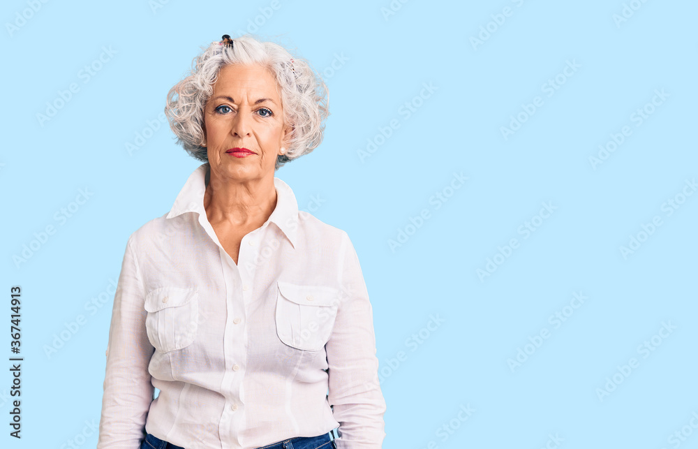 Senior grey-haired woman wearing casual clothes relaxed with serious expression on face. simple and natural looking at the camera.