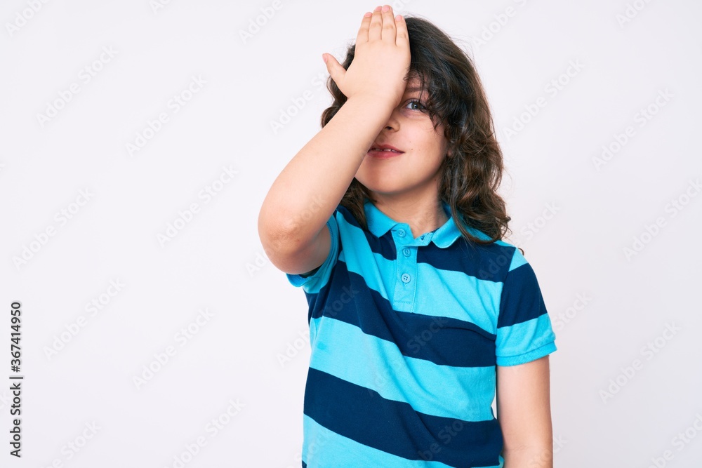 Cute hispanic child with long hair wearing casual clothes surprised with hand on head for mistake, remember error. forgot, bad memory concept. Cute hispanic child with long hair wearing casual clothes surprised with hand on head for mistake, remember error. forgot, bad memory concept.