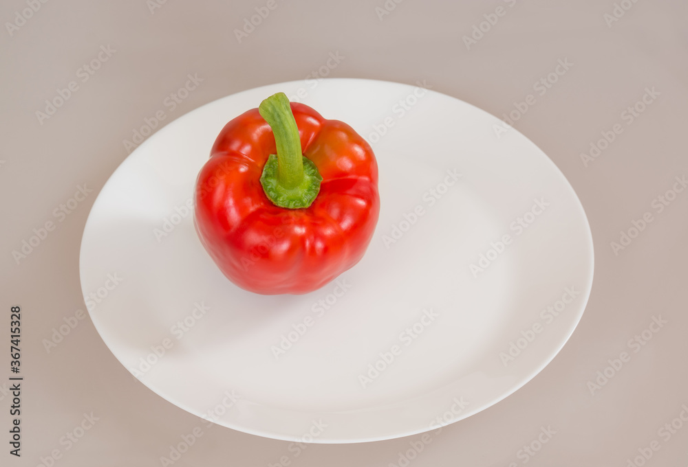 Red bell pepper on a white plate Red bell pepper on a white plate