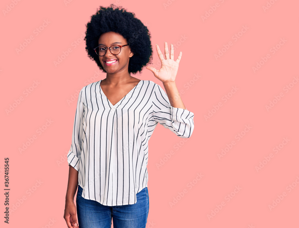 Young african american woman wearing casual clothes and glasses showing and pointing up with fingers number five while smiling confident and happy. Young african american woman wearing casual clothes and glasses showing and pointing up with fingers number five while smiling confident and happy.