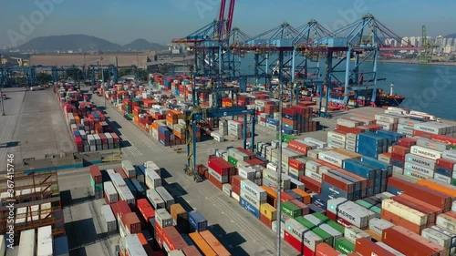 aerial view from busy industrial port with crane and containers from above. It is an import and export cargo port where is a part of shipping dock
 photo