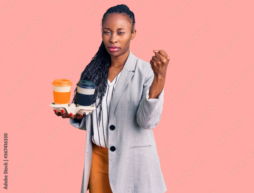 Young african american woman wearing business clothes holding take away cup of coffee annoyed and frustrated shouting with anger, yelling crazy with anger and hand raised Young african american woman wearing business clothes holding take away cup of coffee annoyed and frustrated shouting with anger, yelling crazy with anger and hand raised