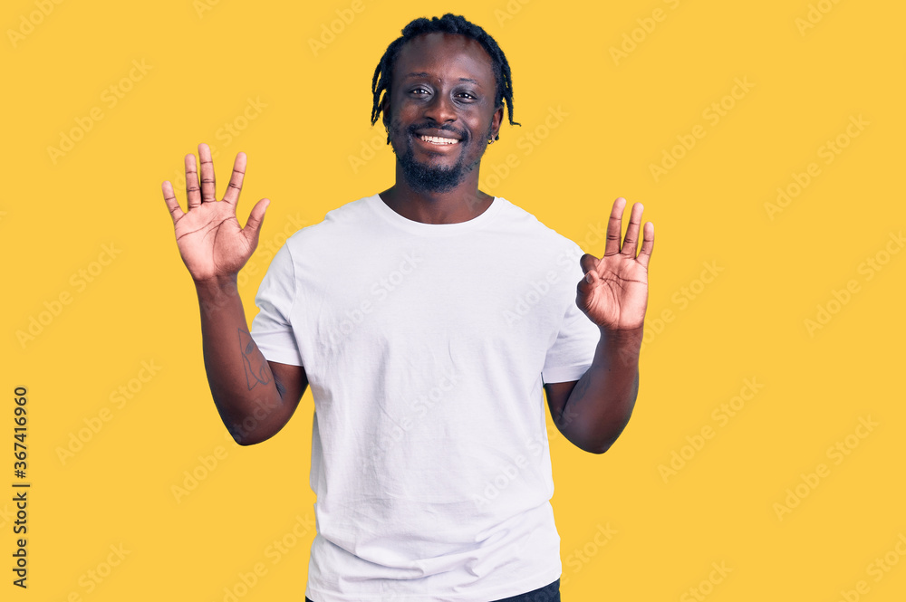 Young african american man with braids wearing casual white tshirt showing and pointing up with fingers number eight while smiling confident and happy. Young african american man with braids wearing casual white tshirt showing and pointing up with fingers number eight while smiling confident and happy.