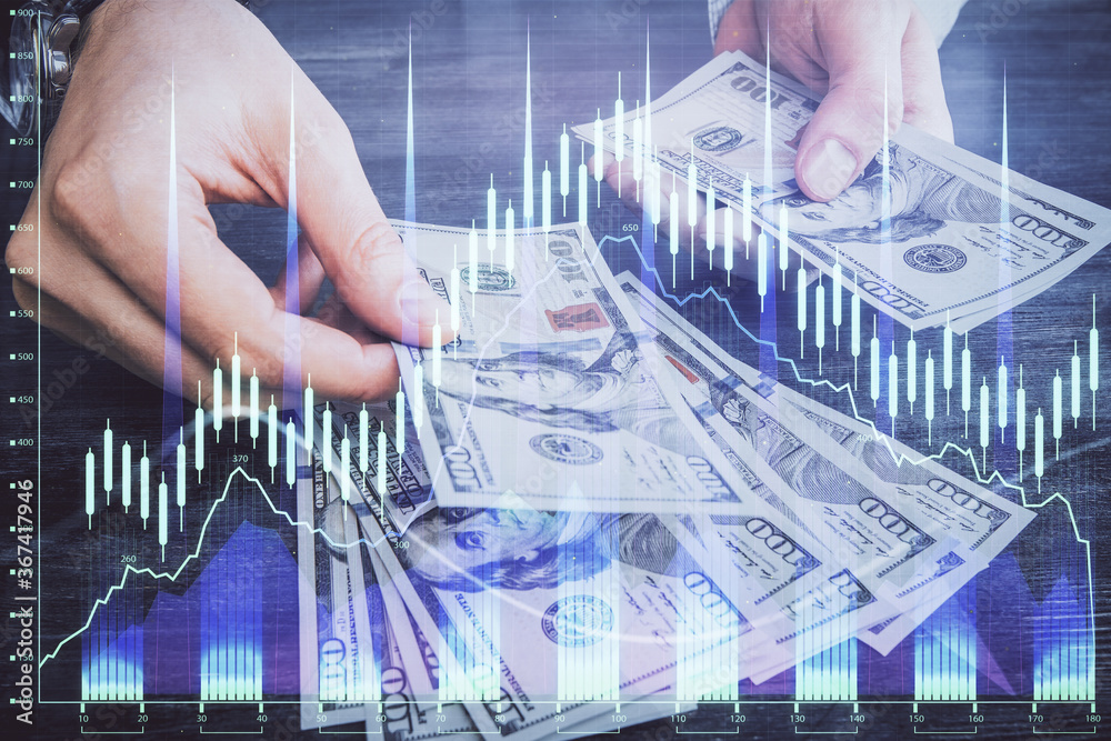 Multi exposure of financial graph drawing hologram and USA dollars bills and man hands. Analysis concept. Multi exposure of financial graph drawing hologram and USA dollars bills and man hands. Analysis concept.