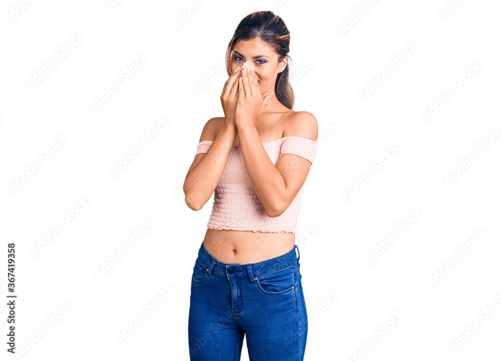 Young beautiful woman wearing casual clothes laughing and embarrassed giggle covering mouth with hands, gossip and scandal concept Young beautiful woman wearing casual clothes laughing and embarrassed giggle covering mouth with hands, gossip and scandal concept