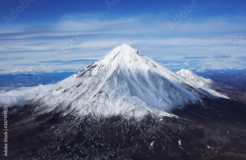 Snow-covered volcano of Kamchatka Peninsula close up. View from Avachinsky volcano to Koryaksky volcano