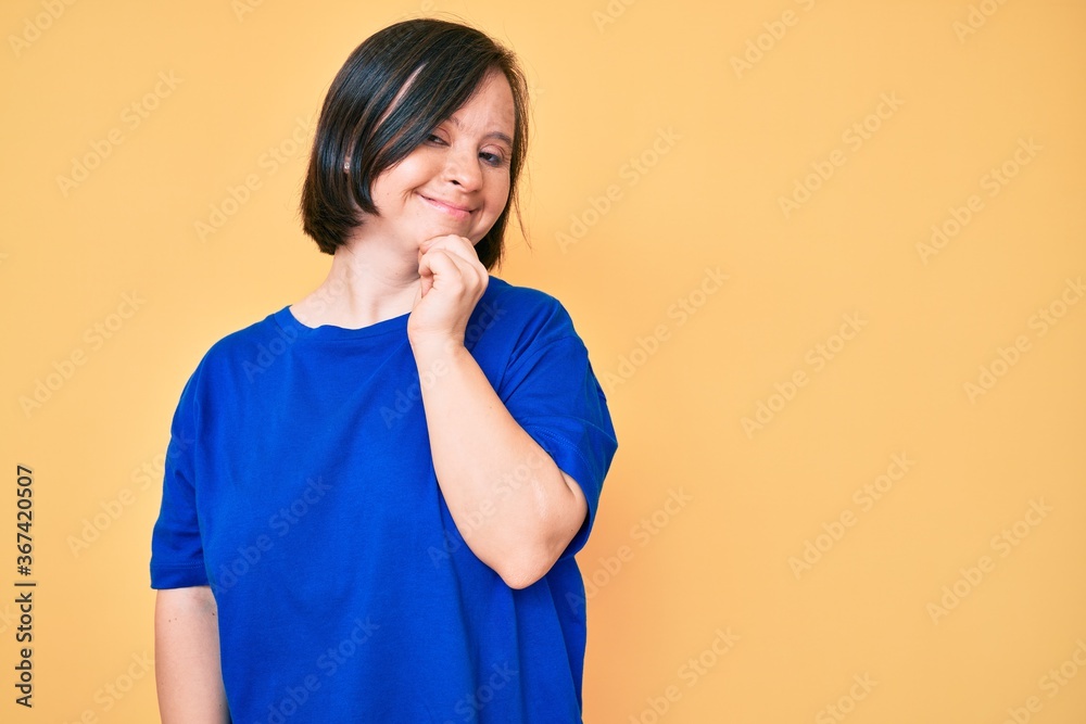 Brunette woman with down syndrome wearing casual clothes smiling looking confident at the camera with crossed arms and hand on chin. thinking positive. Brunette woman with down syndrome wearing casual clothes smiling looking confident at the camera with crossed arms and hand on chin. thinking positive.