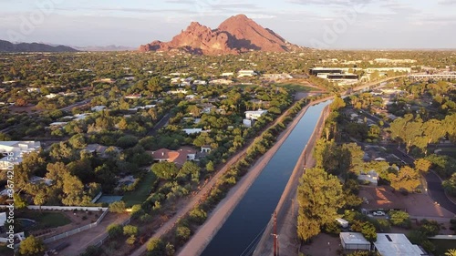 Aerial footage of Phoenix, Arizona with Camelback Mountain glowing red in the evening sun.   