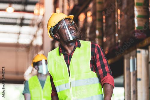Diversity warehouse worker in face mask and shield as new normal work 