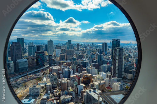 Japan. Osaka. View of Osaka from the window. Panorama of Osaka from a height. Island of Honshu. The urban landscape of Japan. Urbanistics. Modern buildings in Japan. House with helipad.
