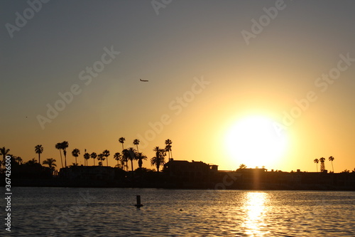 Sunset with plane in background.