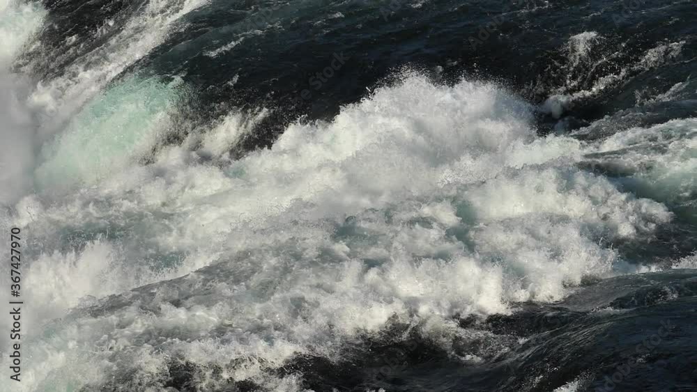 Powerful Waterfall Of Rhine Falls - Tourist Destination In Neuhausen am Rheinfall In The Canton Of Schaffhausen In Switzerland.- close up - slow motion Powerful Waterfall Of Rhine Falls - Tourist Destination In Neuhausen am Rheinfall In The Canton Of Schaffhausen In Switzerland.- close up - slow motion