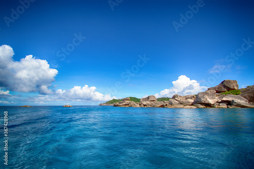 Asian rocky shore, emerald water and clouds © Mikhail Vetyutnev