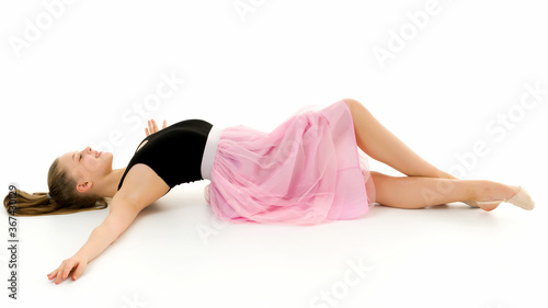 Beautiful Preteen Girl Lying on the Floor Against White Background © lotosfoto