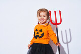Happy Halloween. A child in a devil costume with a Trident.