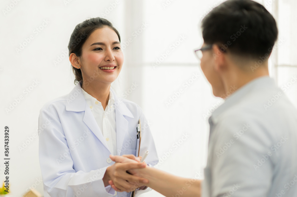 Asian female doctor meet the male patient and shaking hand. Asian female doctor meet the male patient and shaking hand.