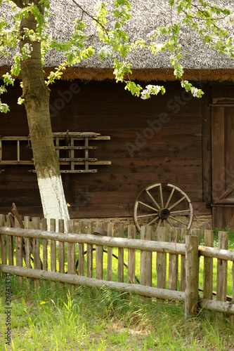 An image of an old village with a house and a fence