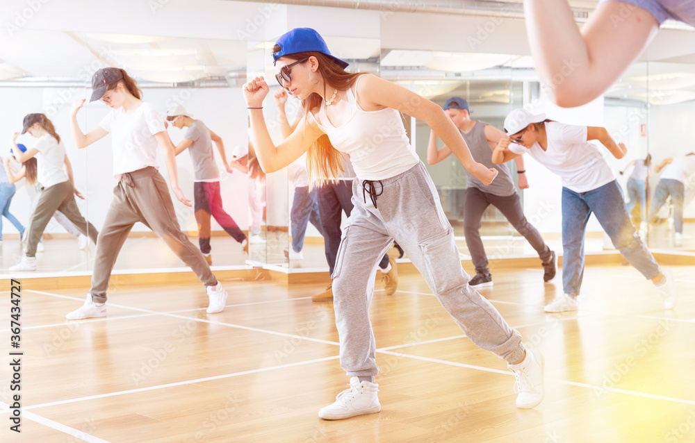 Teens dancing hip-hop dance together in the dance hall