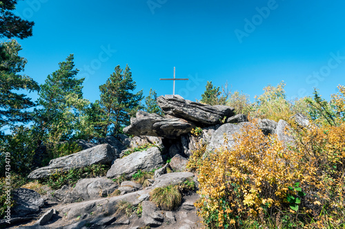 Bizarre rock with an Orthodox cross. Church mountain. Belokurikha resort Russia. photo