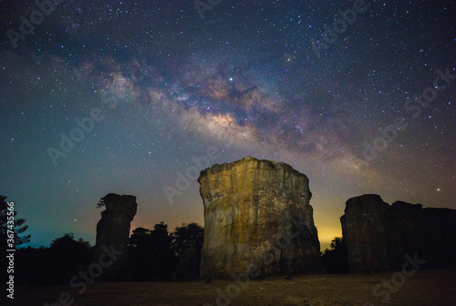Night sky view with some noise of Milky way galaxy and have big rocks foreground. 
