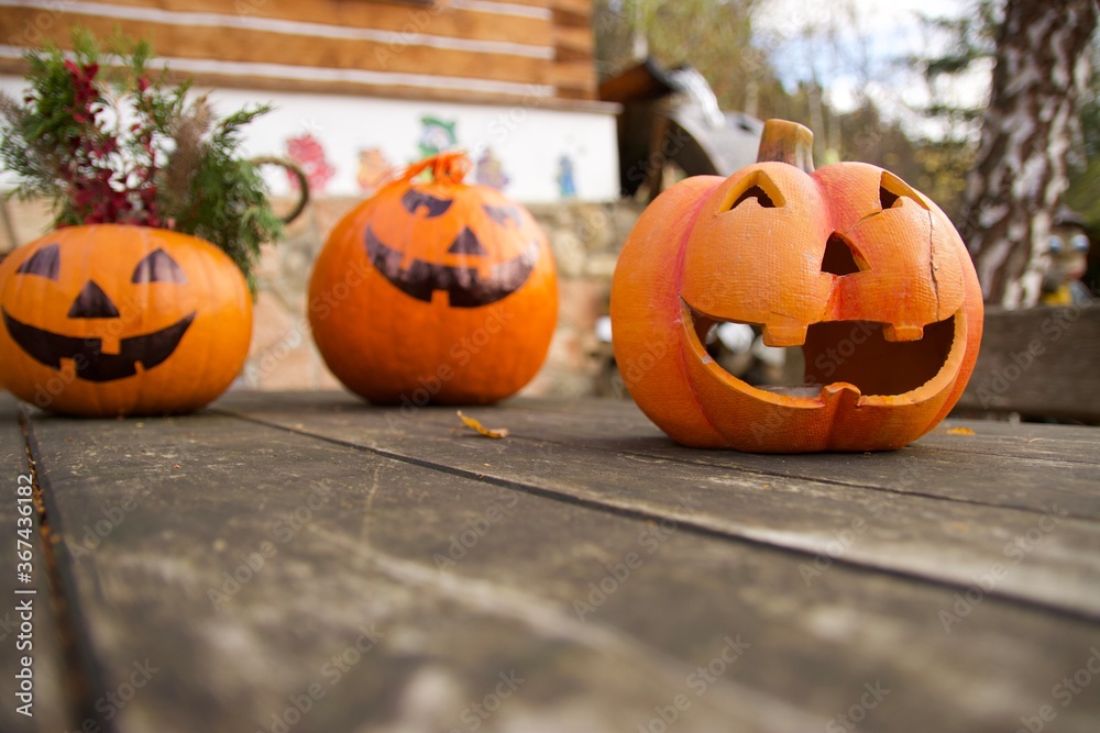Three beautiful cute Halloween pumpkins on the table, each different, greeting customers Three beautiful cute Halloween pumpkins on the table, each different, greeting customers