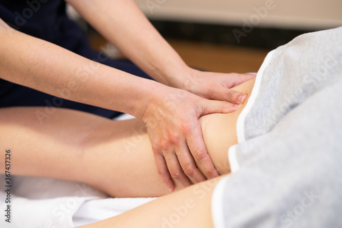 Medical massage at the leg in a physiotherapy center.