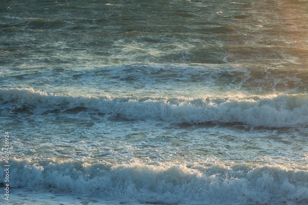 Fototapeta premium the waves of the black sea illuminated by dawn