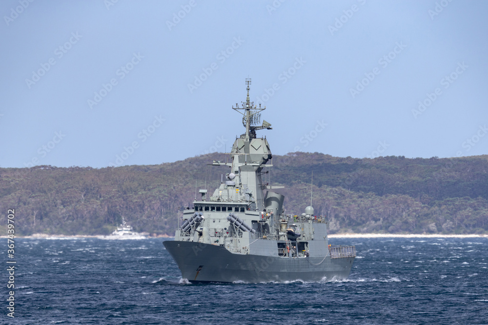 Navy warship heading into a harbor. Navy warship heading into a harbor.