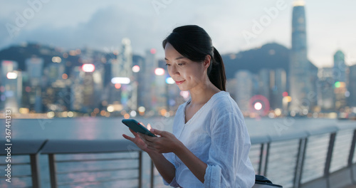 Photography Woman sends sms on cellphone at night