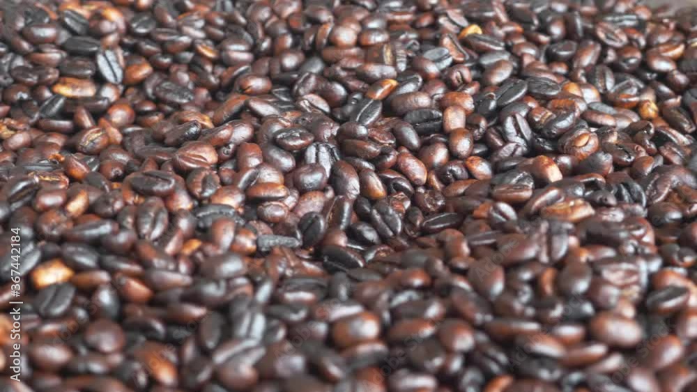 Close up shot to the coffee beans after being roasted, with little focus shift, to show the coffee quality. Close up shot to the coffee beans after being roasted, with little focus shift, to show the coffee quality.