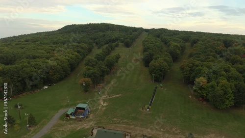 Bird's eye view of un-used ski mountain in the summer with lush forest photo