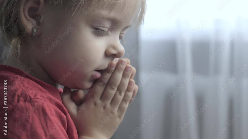 little daughter lifestyle girl makes a wish prayers bedtime religion concept . prayer child indoors praying by bed in front of window little daughter lifestyle girl makes a wish prayers bedtime religion concept . prayer child indoors praying by bed in front of window
