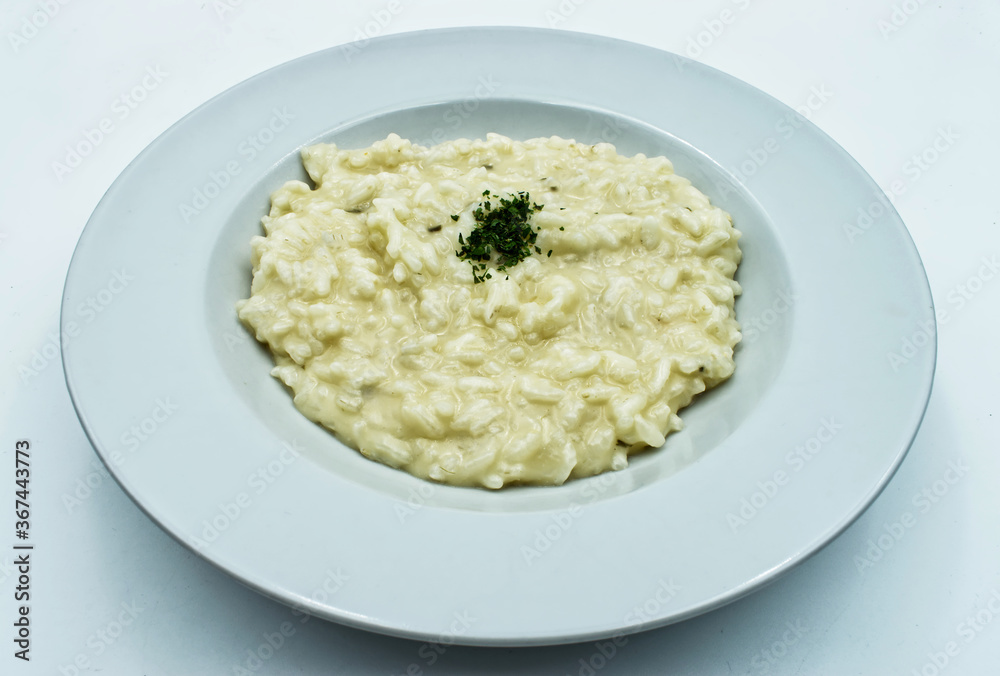 Risotto with cheese (risotto alla parmigiana) isolated on white background Risotto with cheese (risotto alla parmigiana) isolated on white background