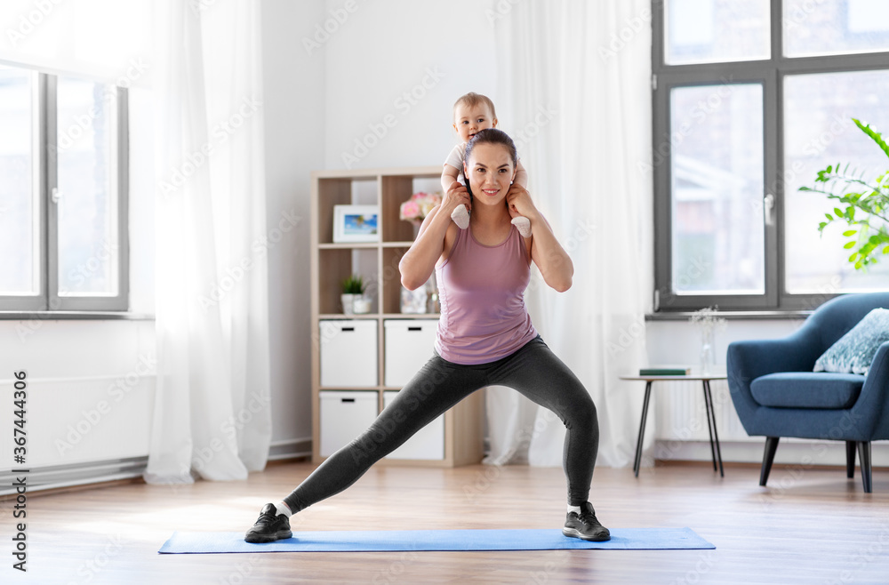 family, sport and motherhood concept - happy smiling mother with little baby exercising at home family, sport and motherhood concept - happy smiling mother with little baby exercising at home