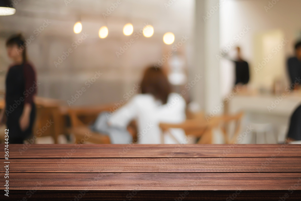 cofee shop blurred background with wooden desk space montage.