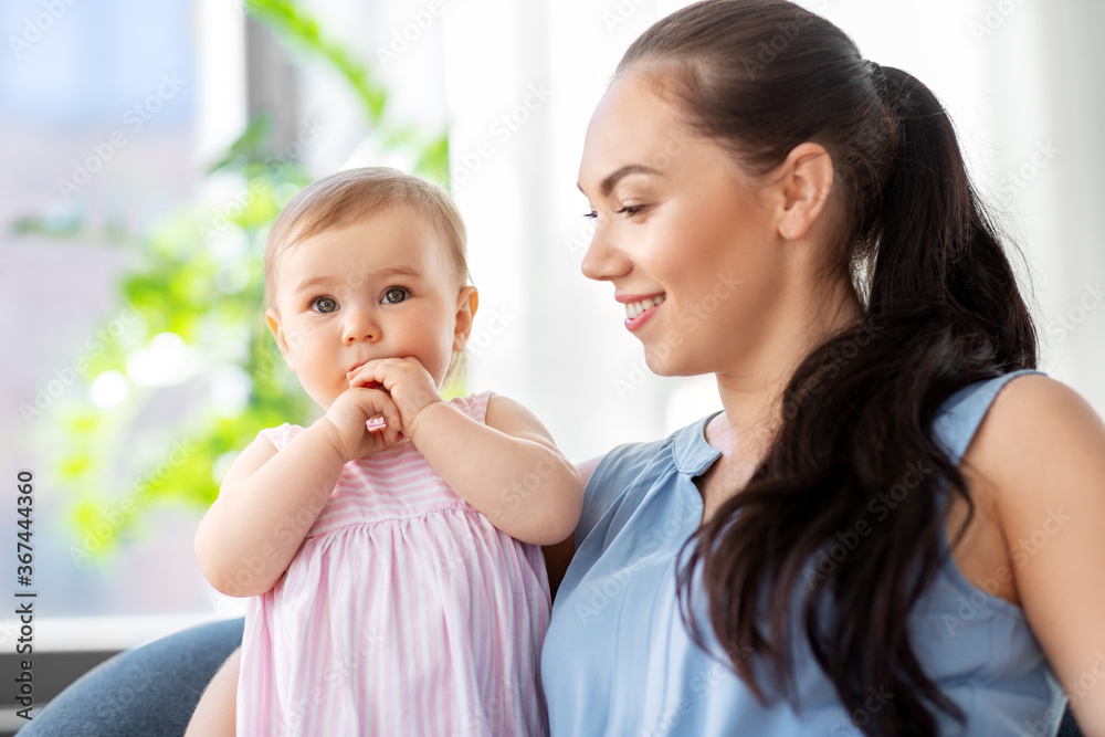 family, child and motherhood concept - portrait of happy smiling mother with little baby daughter at home family, child and motherhood concept - portrait of happy smiling mother with little baby daughter at home