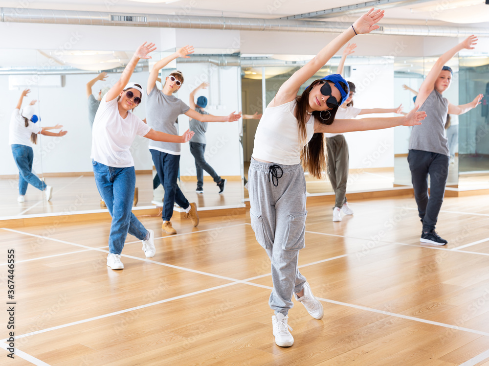 Joyous boy and girls dancing hip hop at lesson in the dance class