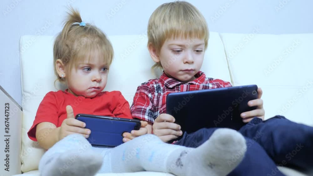 happy family teamwork kids watch online streaming video on a smartphone. children little boy and girl lifestyle brother sister watch online streaming broadcasting cartoons on the phone happy family teamwork kids watch online streaming video on a smartphone. children little boy and girl lifestyle brother sister watch online streaming broadcasting cartoons on the phone