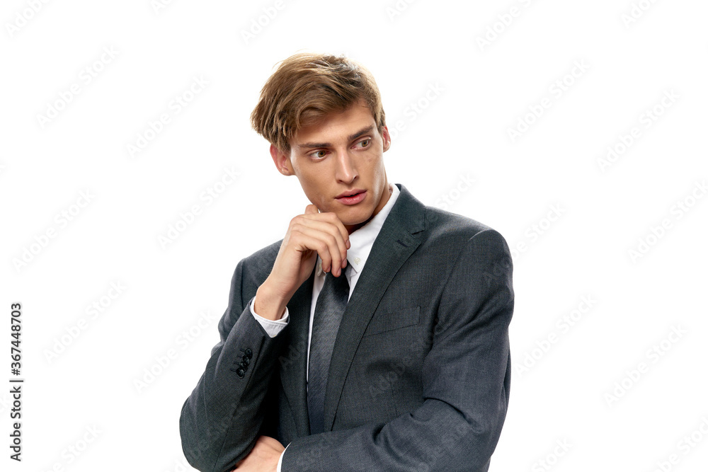 businessman in a tie and jacket looks to the side on an isolated background businessman in a tie and jacket looks to the side on an isolated background