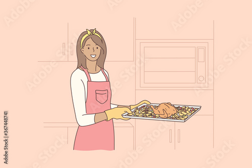 Cooking, food, hobby, housework concept. Young happy smiling african american woman housewife holding hot tray baked chicken with oven gloves looking at camera. Domestic chores and healthy lifetyle.