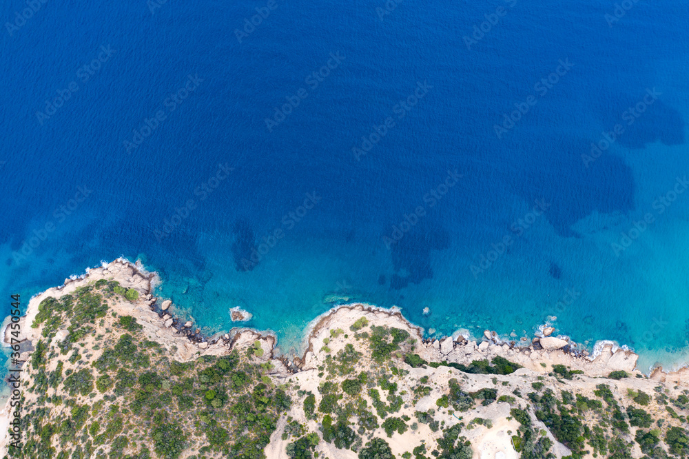 Aerial view of rock formations at beautiful Thassos Islands,Greece from a drone with a turquoise blue ocean during sunrise