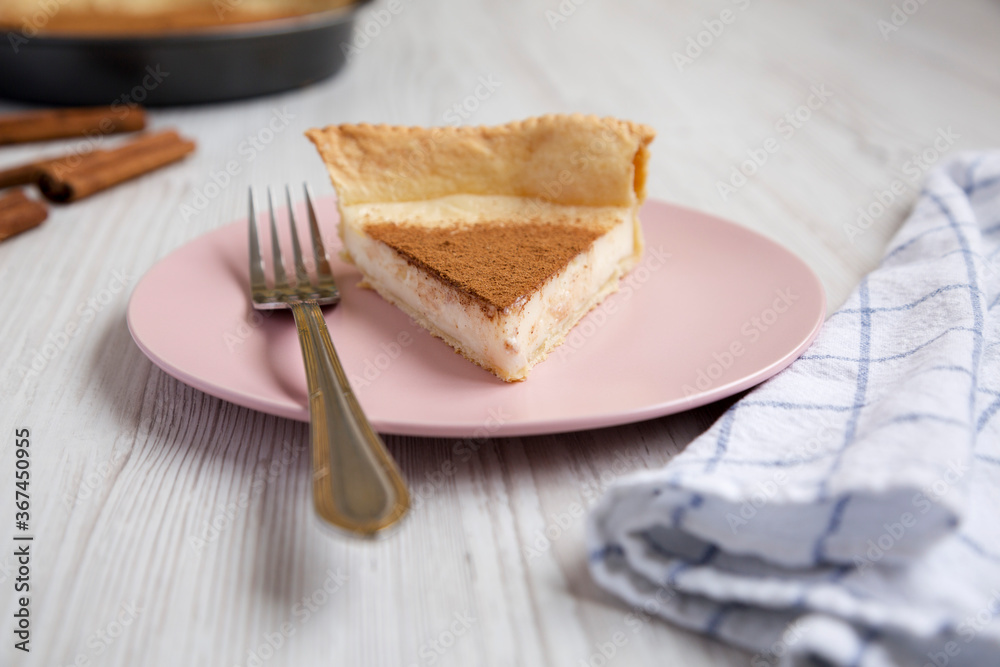 Homemade Sugar Cream Pie on a pink plate on a white wooden table, side view. Homemade Sugar Cream Pie on a pink plate on a white wooden table, side view.