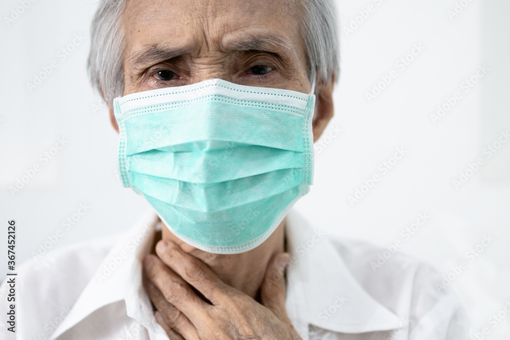 Sick senior in protective mask,old people has sore throat,cough,fever and phlegm in the throat,illness symptom of COVID-19 infection,elderly woman wear face mask to prevent the spread of Coronavirus Sick senior in protective mask,old people has sore throat,cough,fever and phlegm in the throat,illness symptom of COVID-19 infection,elderly woman wear face mask to prevent the spread of Coronavirus