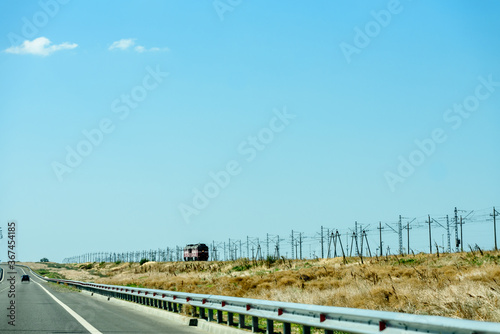Russia, Crimea, September 11, 2019:Cars on the highway to Crimea. Railway and locomotive.