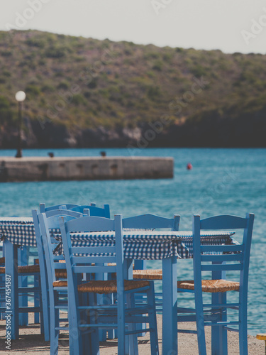 Open cafe outdoor restaurant in Greece on sea shore