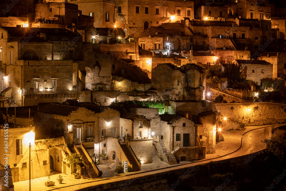 Amazing lighted buildings in ancient Sassi district by night in Matera, well-known for their ancient cave dwellings. Basilicata. Italy Amazing lighted buildings in ancient Sassi district by night in Matera, well-known for their ancient cave dwellings. Basilicata. Italy