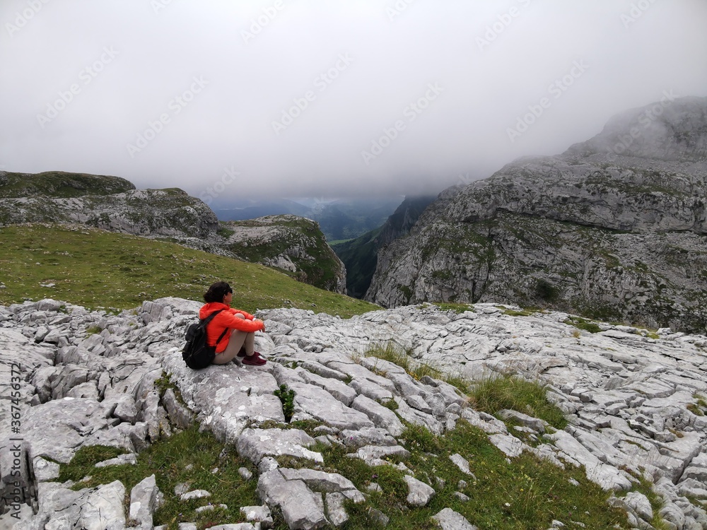 Woman sitting enjoying the high mountain views after a hiking trail