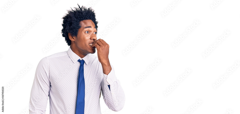 Handsome african american man with afro hair wearing business clothes looking stressed and nervous with hands on mouth biting nails. anxiety problem. Handsome african american man with afro hair wearing business clothes looking stressed and nervous with hands on mouth biting nails. anxiety problem.