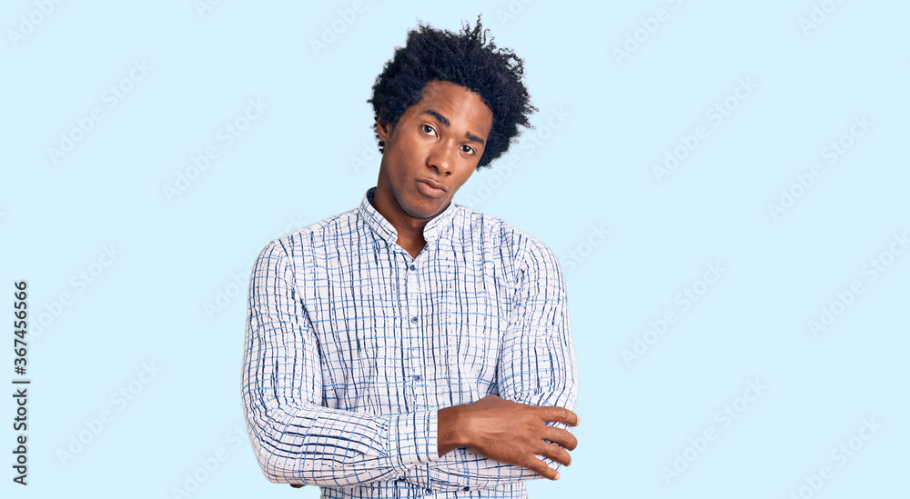 Handsome african american man with afro hair wearing casual clothes skeptic and nervous, disapproving expression on face with crossed arms. negative person. Handsome african american man with afro hair wearing casual clothes skeptic and nervous, disapproving expression on face with crossed arms. negative person.