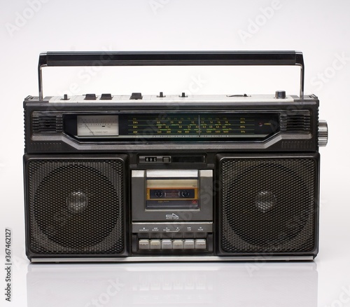 Vintage black boom box on white background with reflection